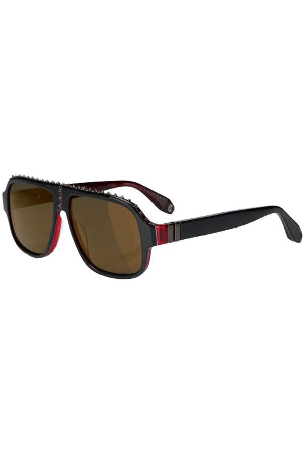 Rotated view of Christian Louboutin moto sunglasses in dark brown with black frame and spiny details, shown against a plaid white background.