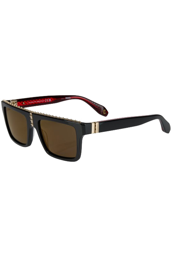 Rotated view of Christian Louboutin sunglasses in dark brown with black frame and spiny details, shown against a plaid white background.