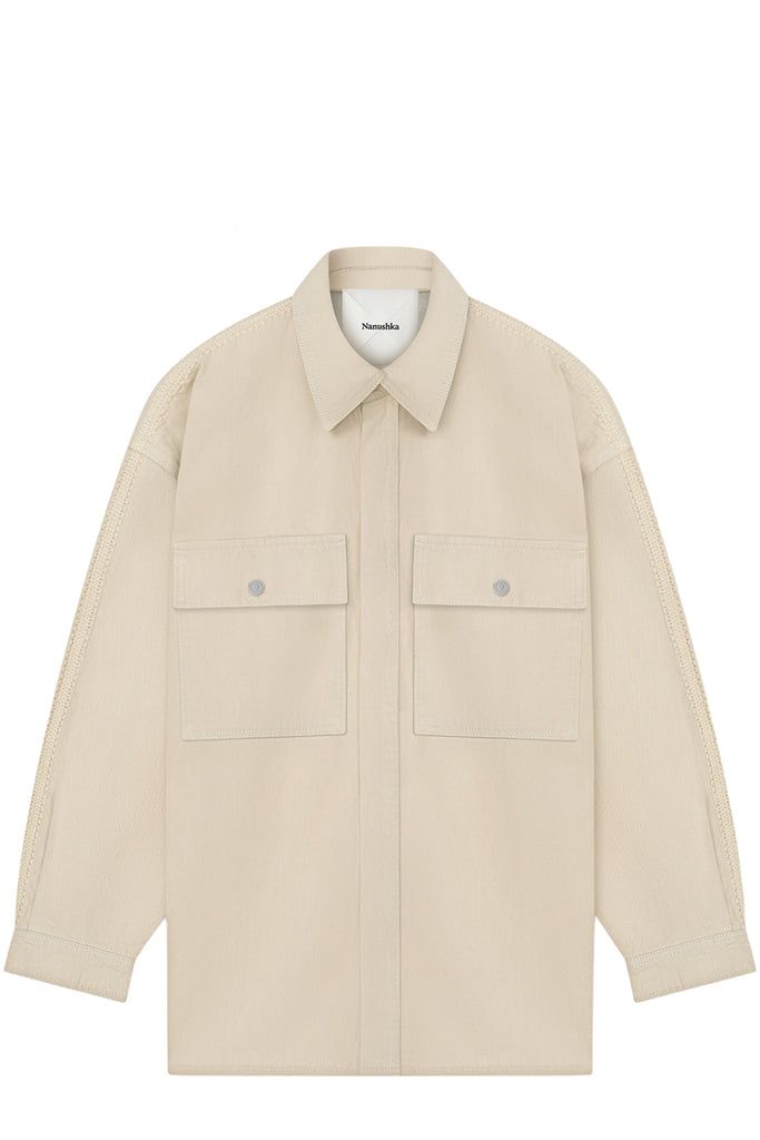 A light beige long-sleeve utility shirt jacket with a pointed collar, button front, and two flap chest pockets, shown flat against a white background.