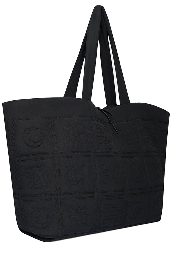 Rotated view of Nanushka quilted tote bag in black, shown against a plaid white background.