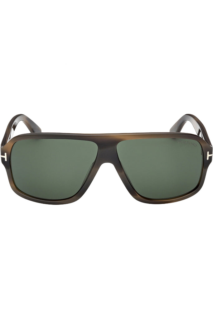 Tom Ford moto sunglasses in green with tortoise frame and metal T details, shown against a plaid white background.