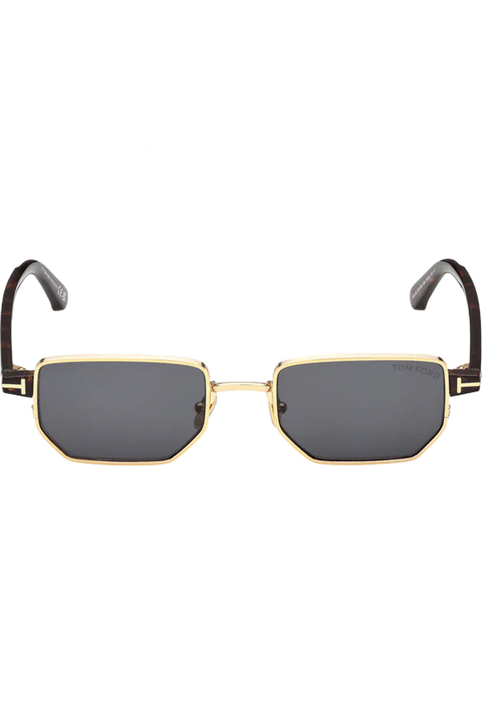 Tom Ford rectangular sunglasses in gray with dark tortoise and metal frame and gold T details, shown against a plaid white background.
