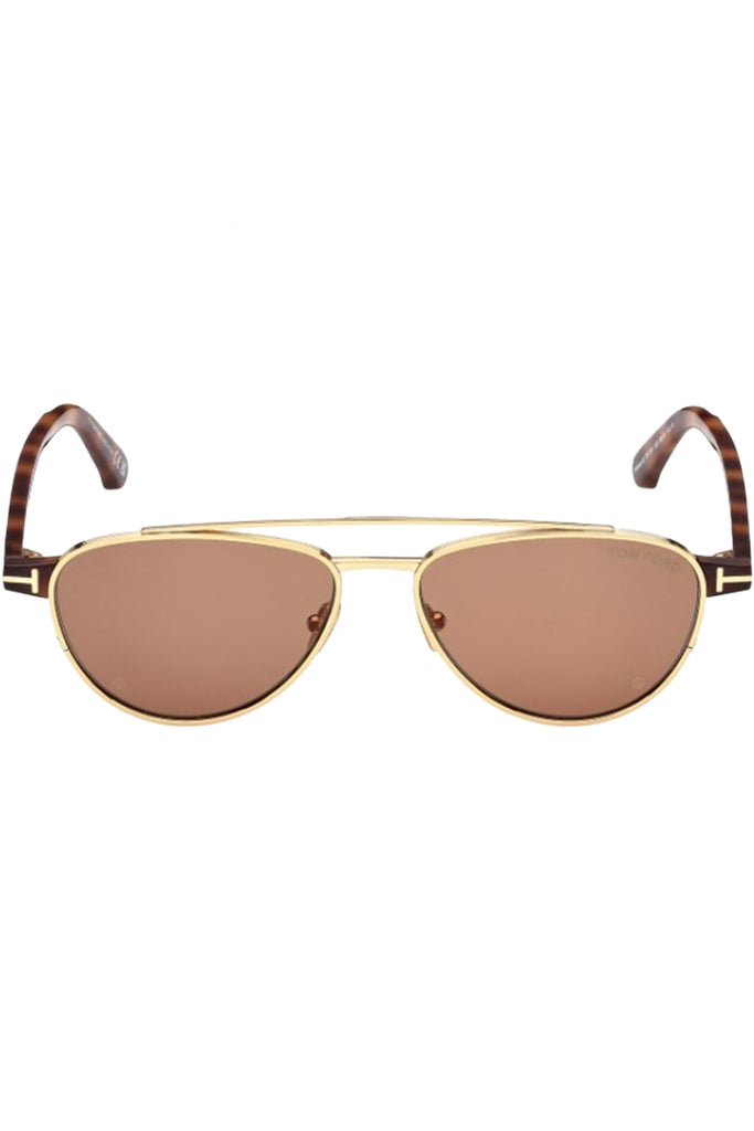 Tom Ford sunglasses in brown with tortoise and metal frame and gold T details, shown against a plaid white background.