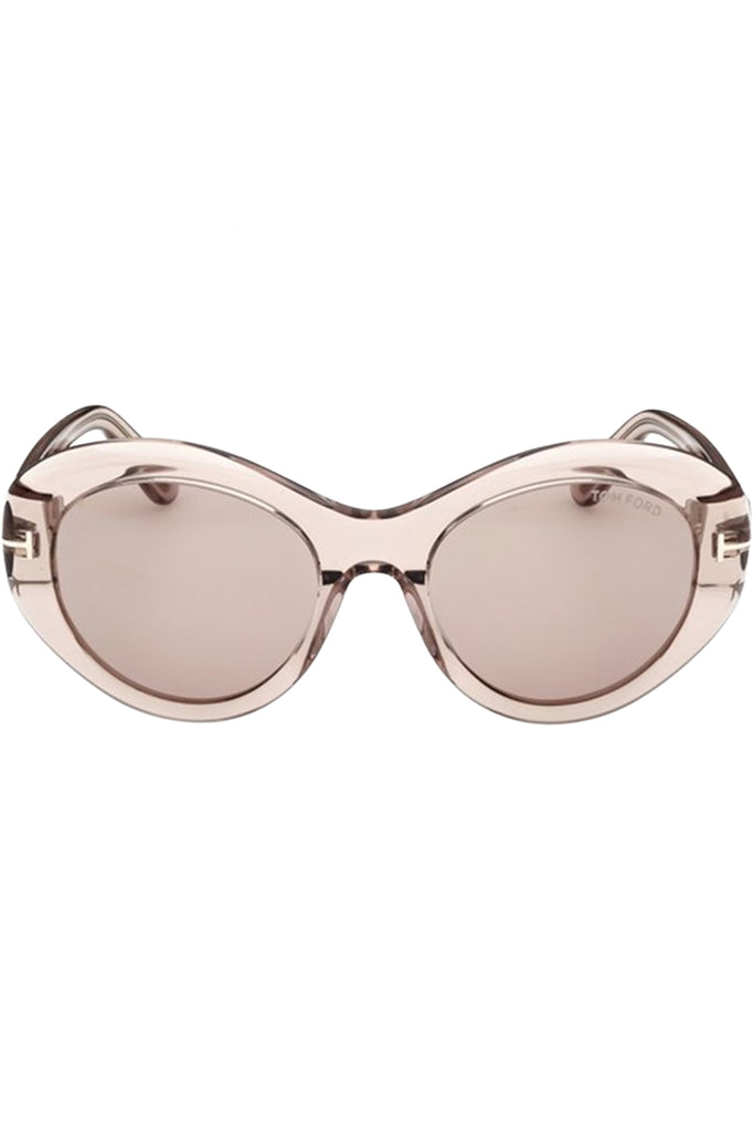 Tom Ford oval sunglasses in pink with translucent pink frame and metal T details, shown against a plaid white background.