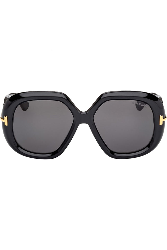 Tom Ford butterfly sunglasses in gray with black frame and gold T details, shown against a plaid white background.