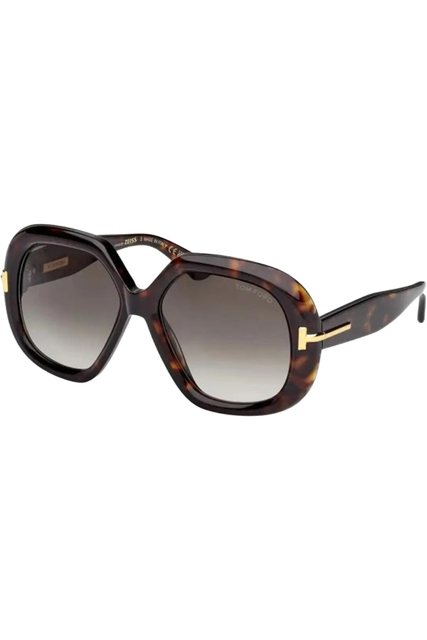 Rotated view of Tom Ford butterfly sunglasses in gray with dark tortoise frame and metal T details, shown against a plaid white background.