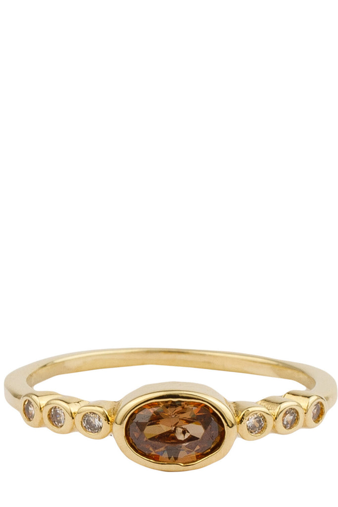 The ellips ring in gold and brown colour from the brand ALL THE LUCK IN THE WORLD