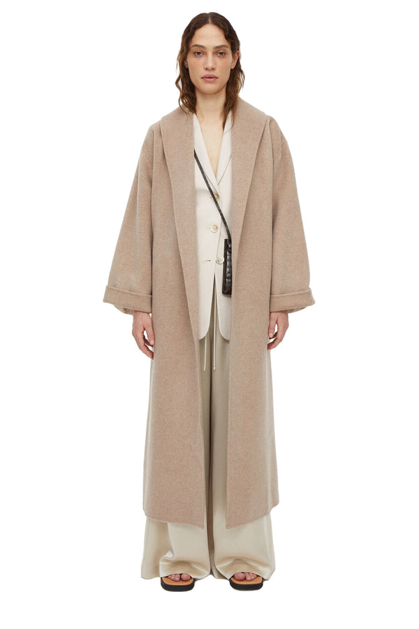 Model wearing the Trullem tie-knot wool coat in sesame color from the brand BY MALENE BIRGER