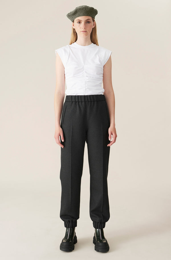 Model wearing the elasticated-waistband wool-blend pants in phantom color from the brand GANNI.