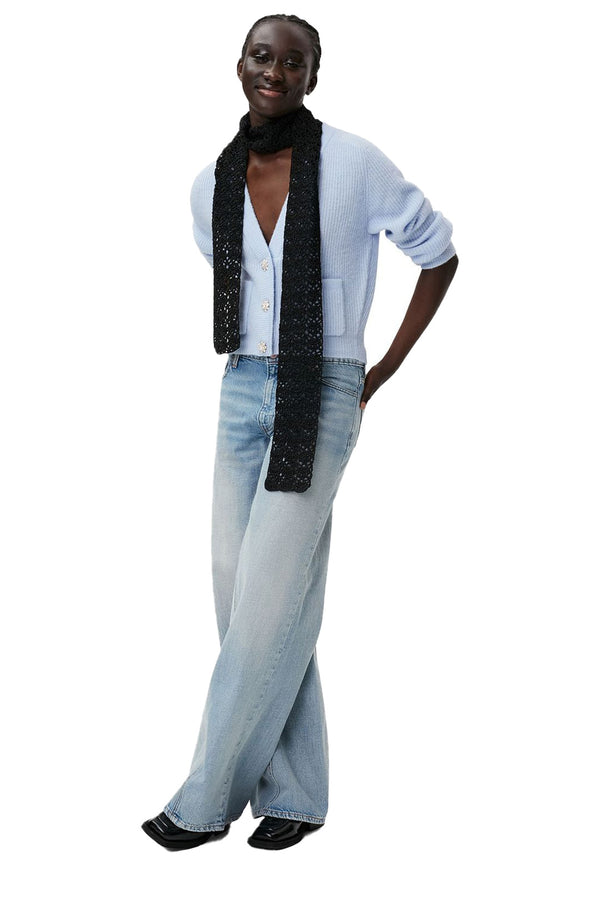 Model wearing the embellished-button knitted wool cardigan in blue color from the brand GANNI.
