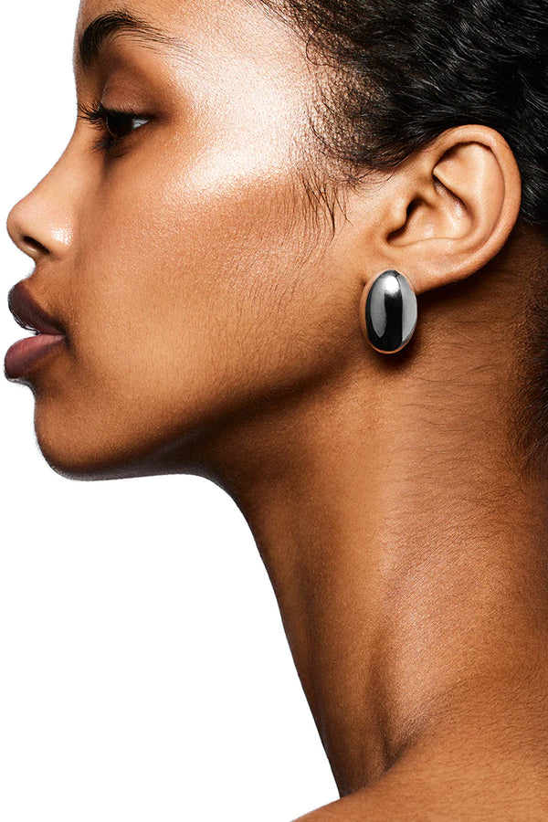 Model wearing the Camille stud earrings in silver colour from the brand LIÉ STUDIO