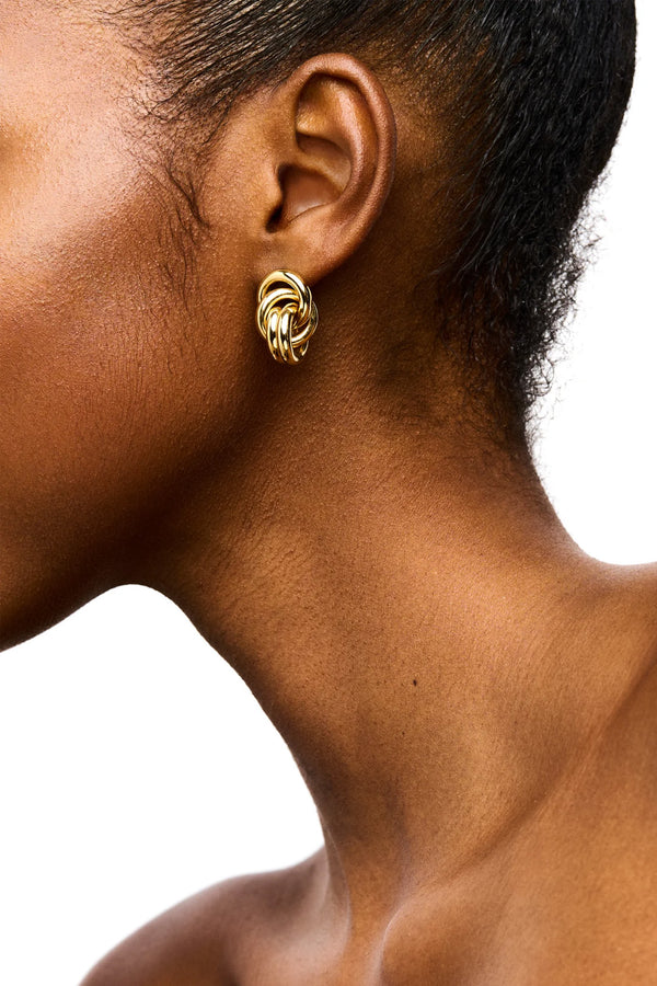 Model wearing the Vera stud earrings in gold colour from the brand LIÉ STUDIO