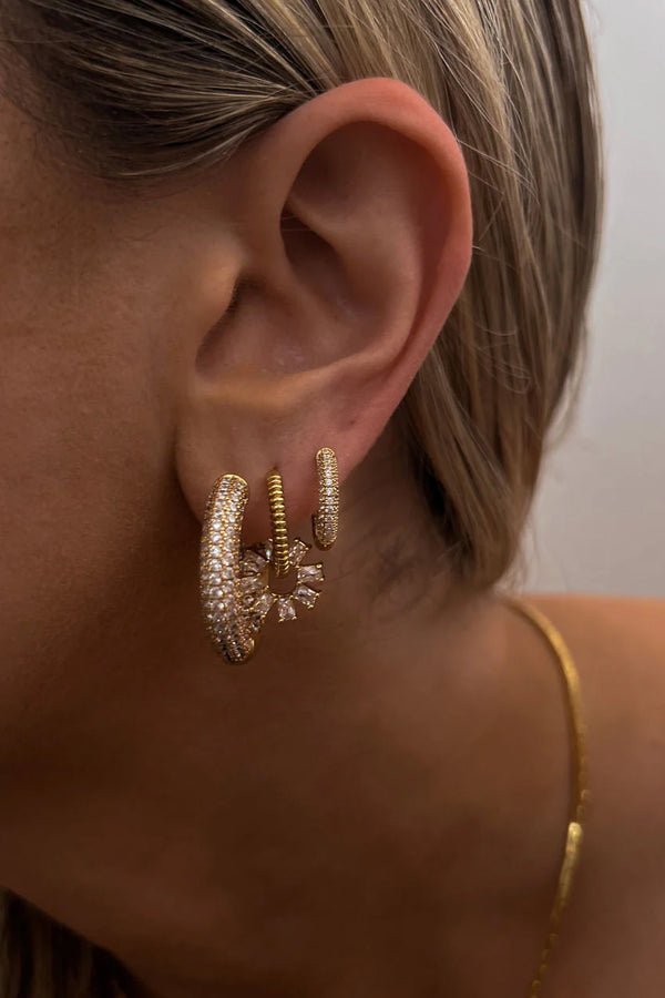 Model wearing the reversible Amalfi hoop earrings in gold colour from the brand LUV AJ