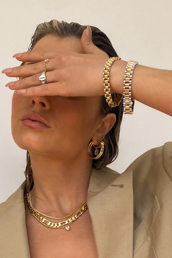 Model wearing the Timepiece bracelet in gold colour from the brand LUV AJ