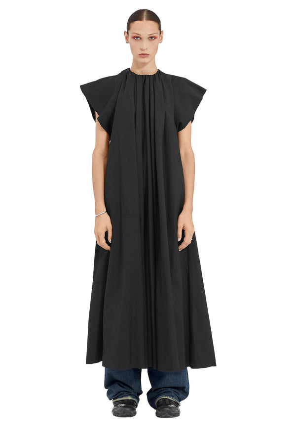 Model wearing the wide-sleeve maxi dress in black colour from the brand MM6 MAISON MARGIELA