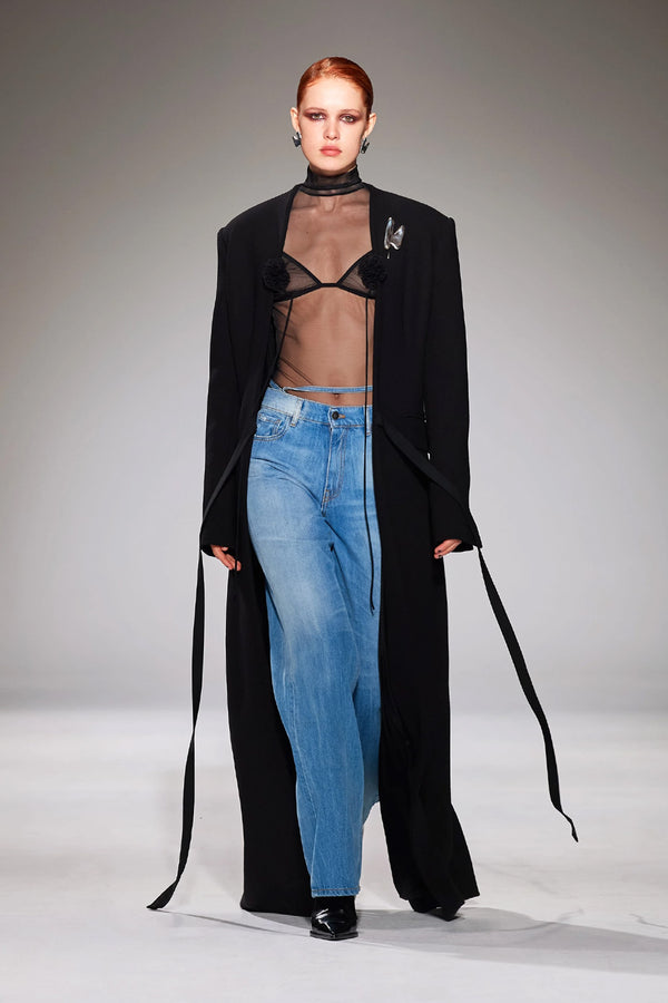 Model wearing the flower-detail mesh triangle bra in black color from the brand NENSI DOJAKA