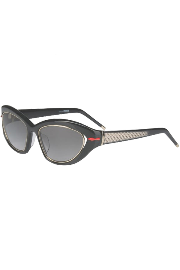 Rotated view of Christian Louboutin cat-eye sunglasses in gray with black frame, red details and metal frame around the lenses, shown against a plaid white background.