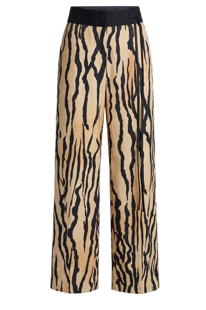 Nanushka printed trousers in beige and black, shown against a plain white background.