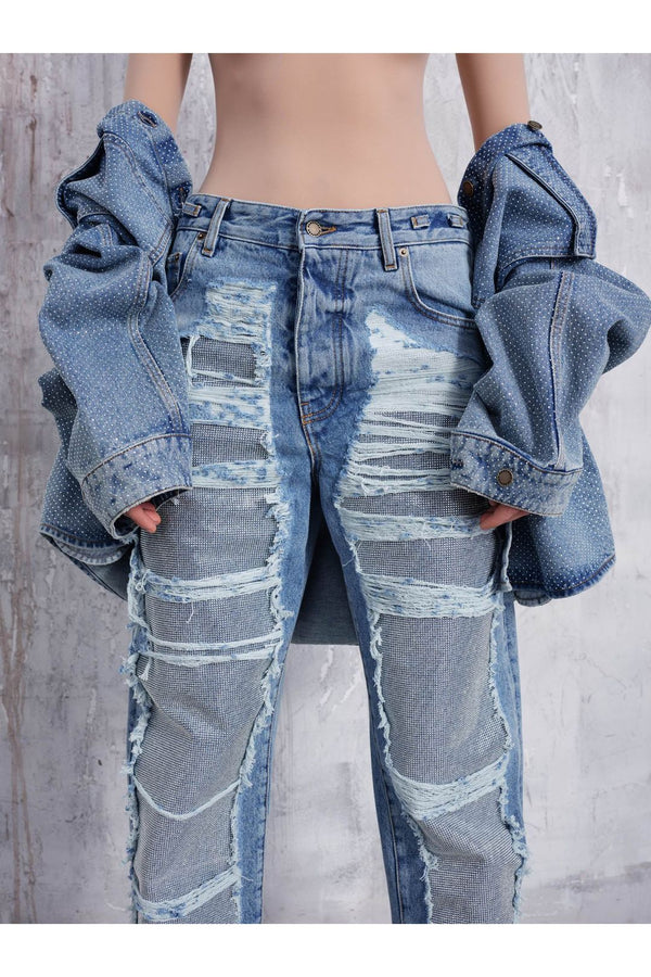 Model wearing the Karen crystal-panel shredded denim jeans in light wash color from the brand DARKPARK